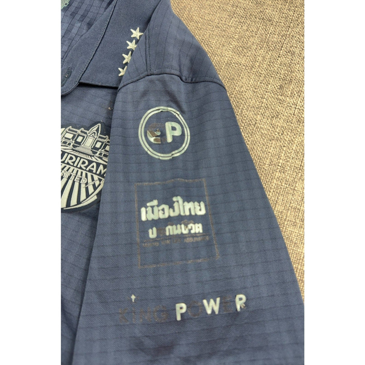 Second Half Supply Co, LLC navy Buriram United soccer jersey sleeve with sponsor logos and embroidered club crest
