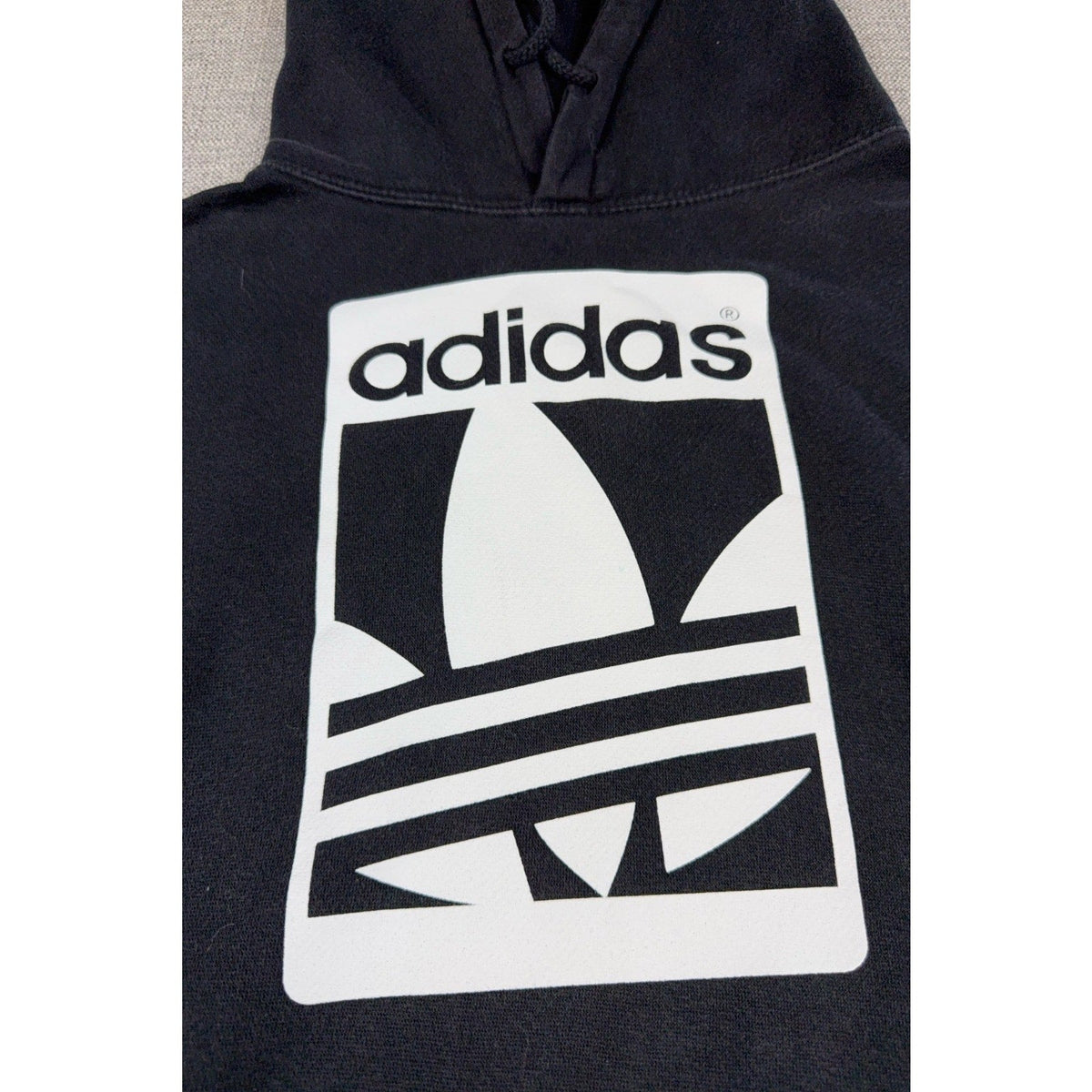 Second Half Supply Co, LLC black Adidas Originals pullover hoodie with large white Trefoil logo graphic on chest