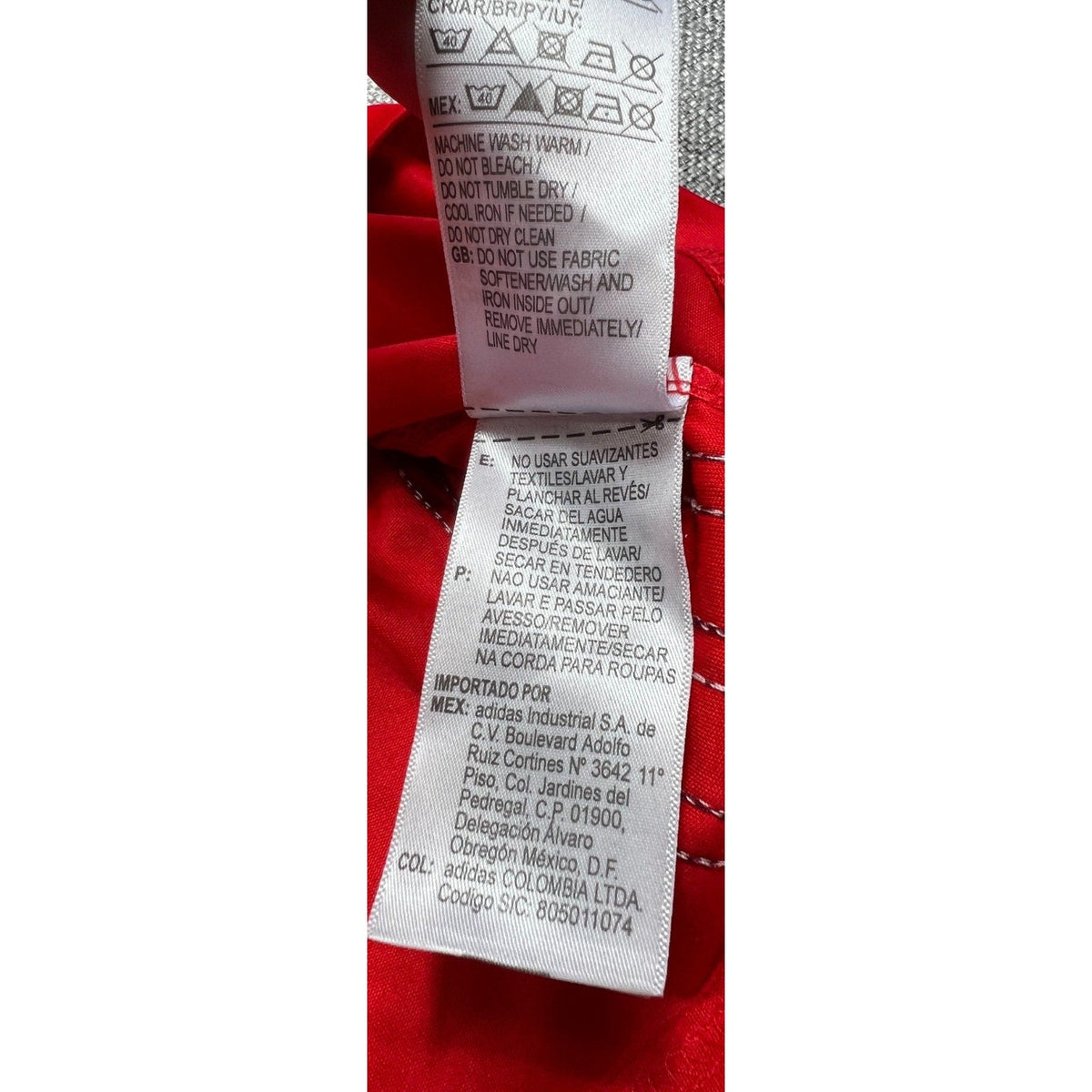 Second Half Supply Co, LLC Adidas soccer jersey care label with washing instructions in English, Spanish, and Portuguese