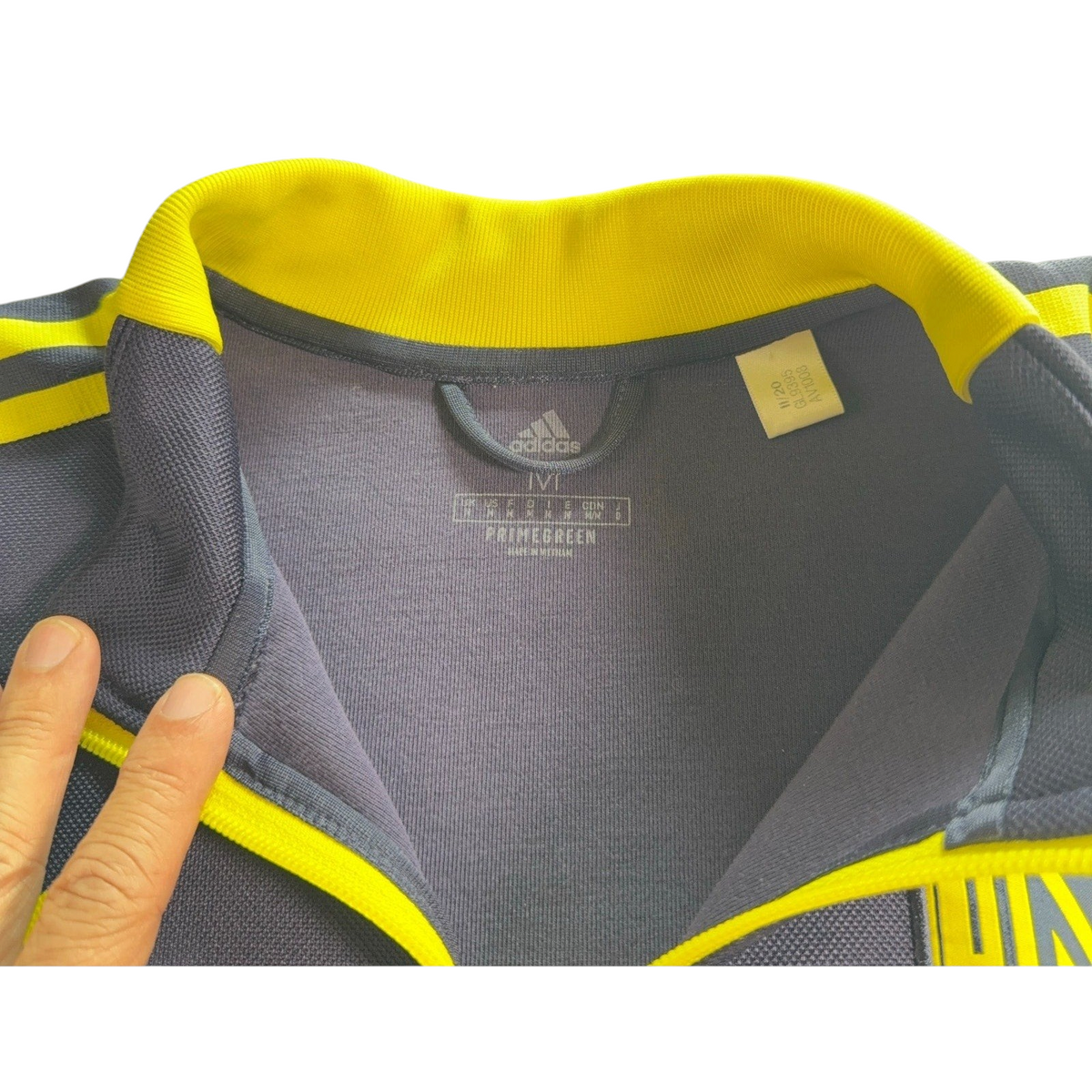 Second Half Supply Co, LLC Adidas Nashville SC track jacket interior collar detail with yellow trim and size tag