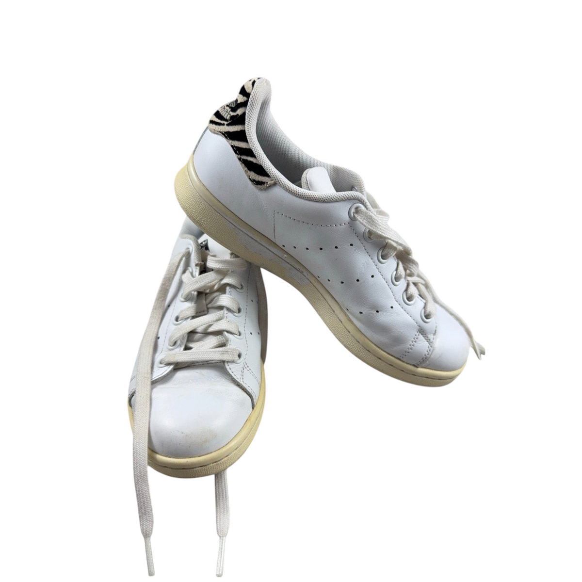 Second Half Supply Co, LLC adidas Stan Smith white leather sneakers with zebra-print heel tabs and yellowed midsoles.