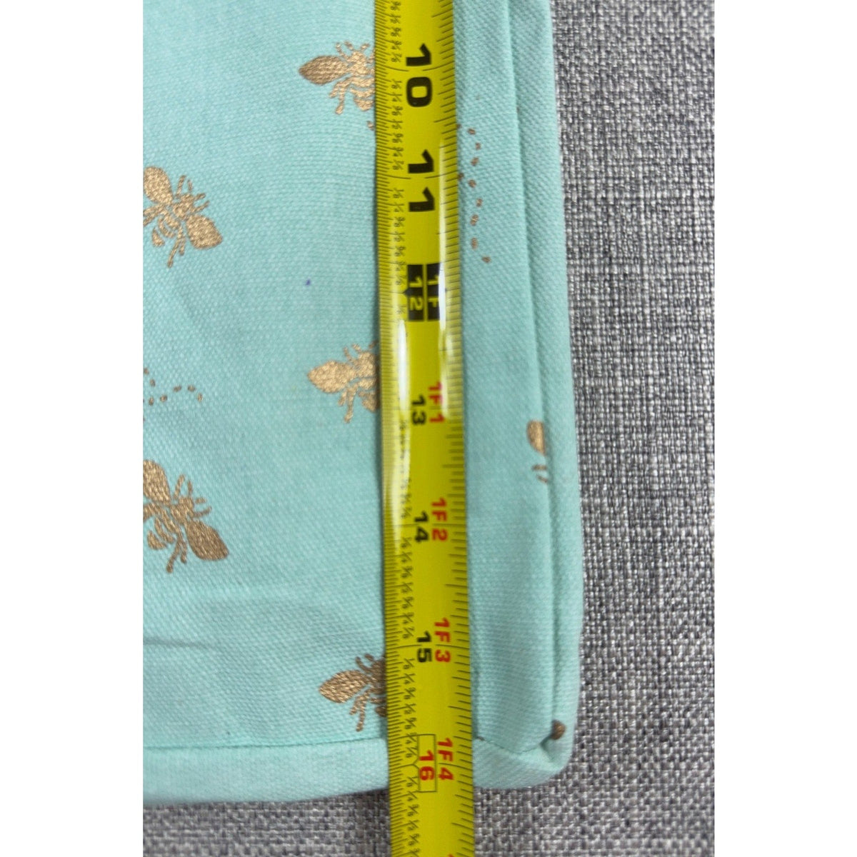 Second Half Supply Co, LLC aqua canvas tote with metallic gold bee print being measured with a yellow tape measure