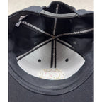 Interior view of a black Second Half Supply Co, LLC Atlanta United FC Adidas snapback hat showing branded tape.