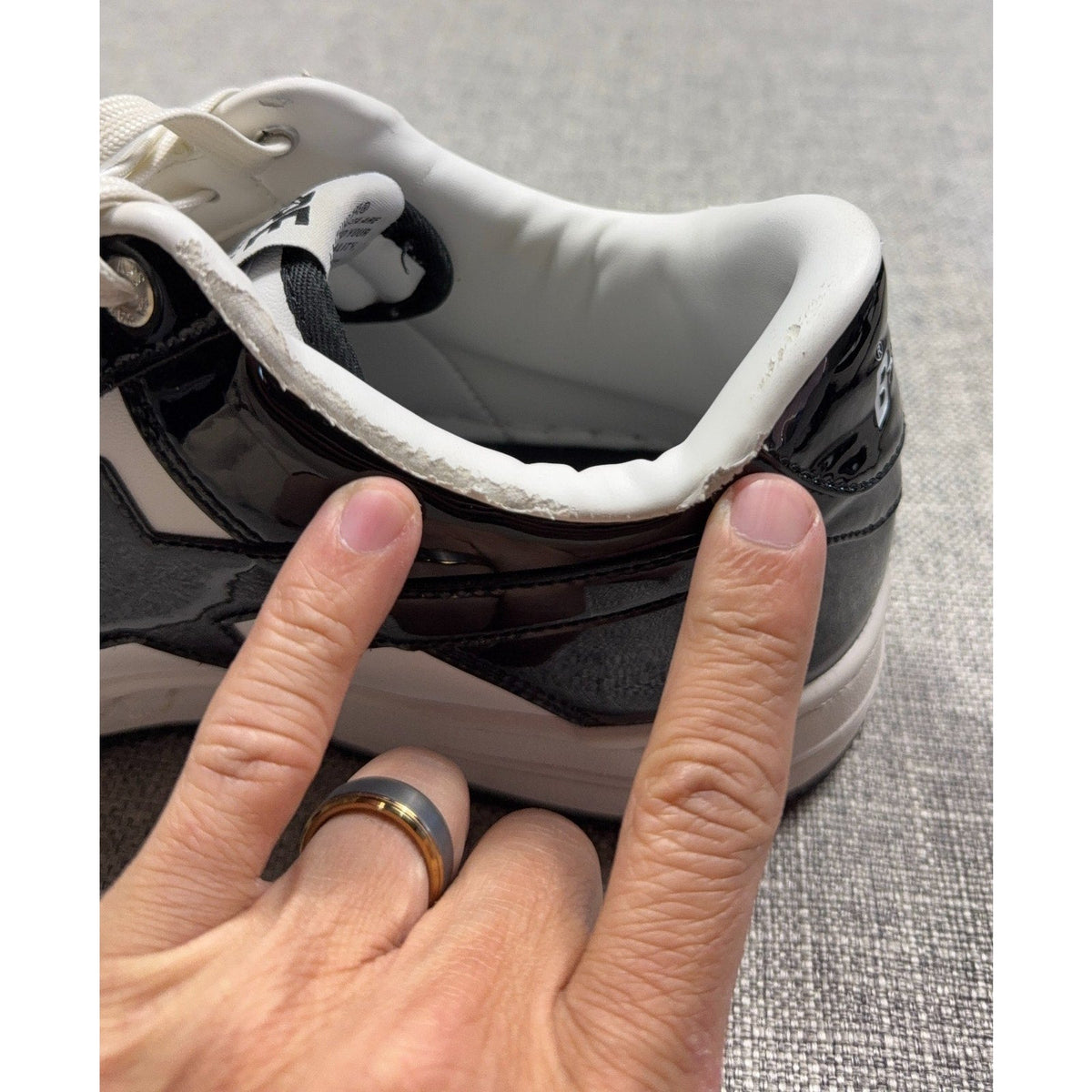 Second Half Supply Co, LLC BAPE STA low sneakers showing peeling and flaking on the black and white ankle collar