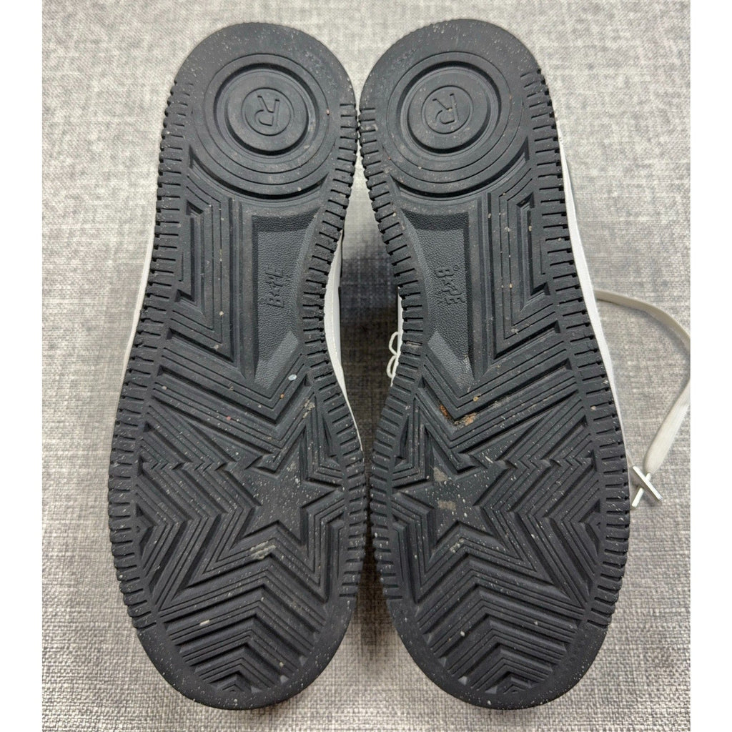 Second Half Supply Co, LLC black rubber outsoles of BAPE STA low-top sneakers featuring star and logo tread patterns.