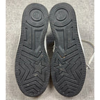Second Half Supply Co, LLC black rubber outsoles of BAPE STA low-top sneakers featuring star and logo tread patterns.