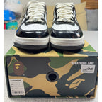 Second Half Supply Co, LLC BAPE STA low-top sneakers in black and white patent leather with silver lace ornaments.