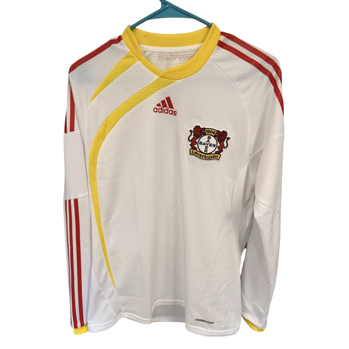 Second Half Supply Co, LLC vintage white Bayer Leverkusen long sleeve soccer jersey with red and yellow accents.