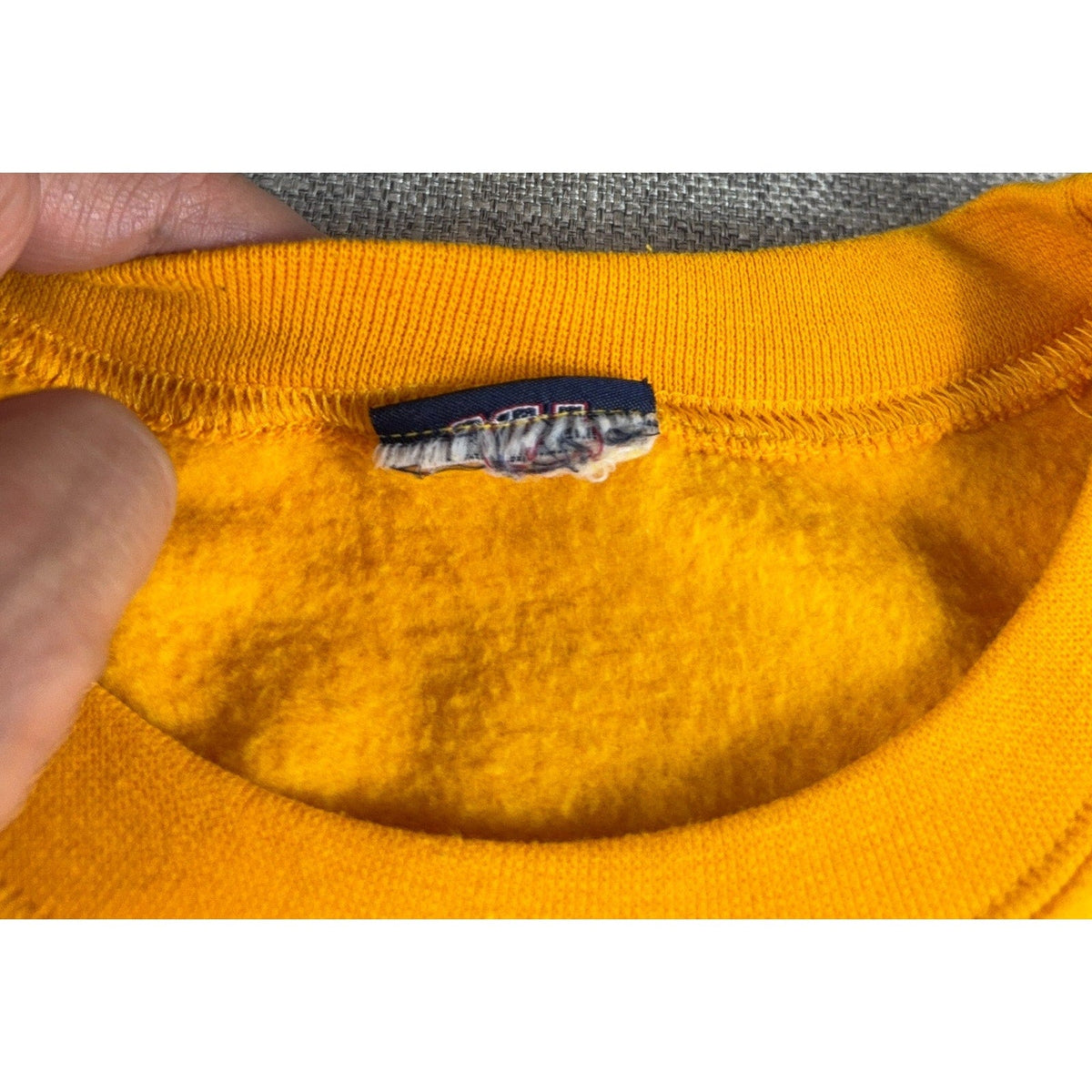 Second Half Supply Co, LLC vintage Baylor sweatshirt gold ribbed crew neckline with partially cut interior brand tag