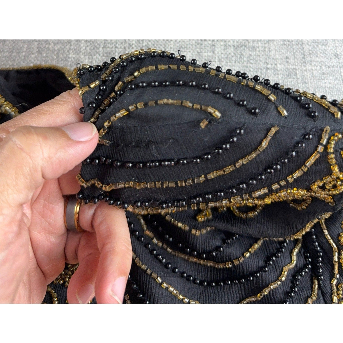 Second Half Supply Co, LLC silk blouse sleeve showing intricate black and antique-gold Art Deco beadwork detail