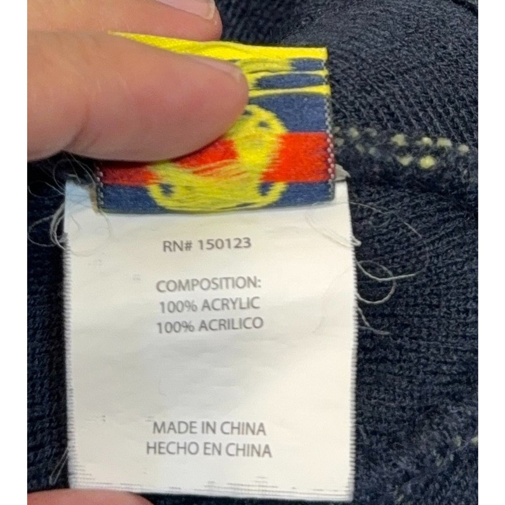 Second Half Supply Co, LLC Club America beanie interior tag showing 100 percent acrylic material and origin