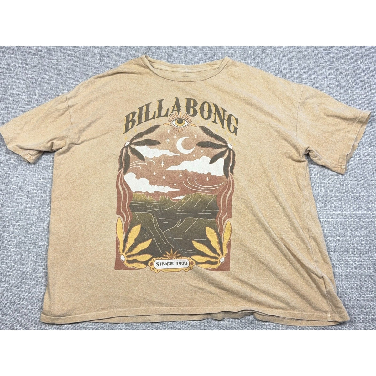Second Half Supply Co, LLC tan Billabong boxy graphic tee featuring a celestial moon, eye, and coastal landscape print.