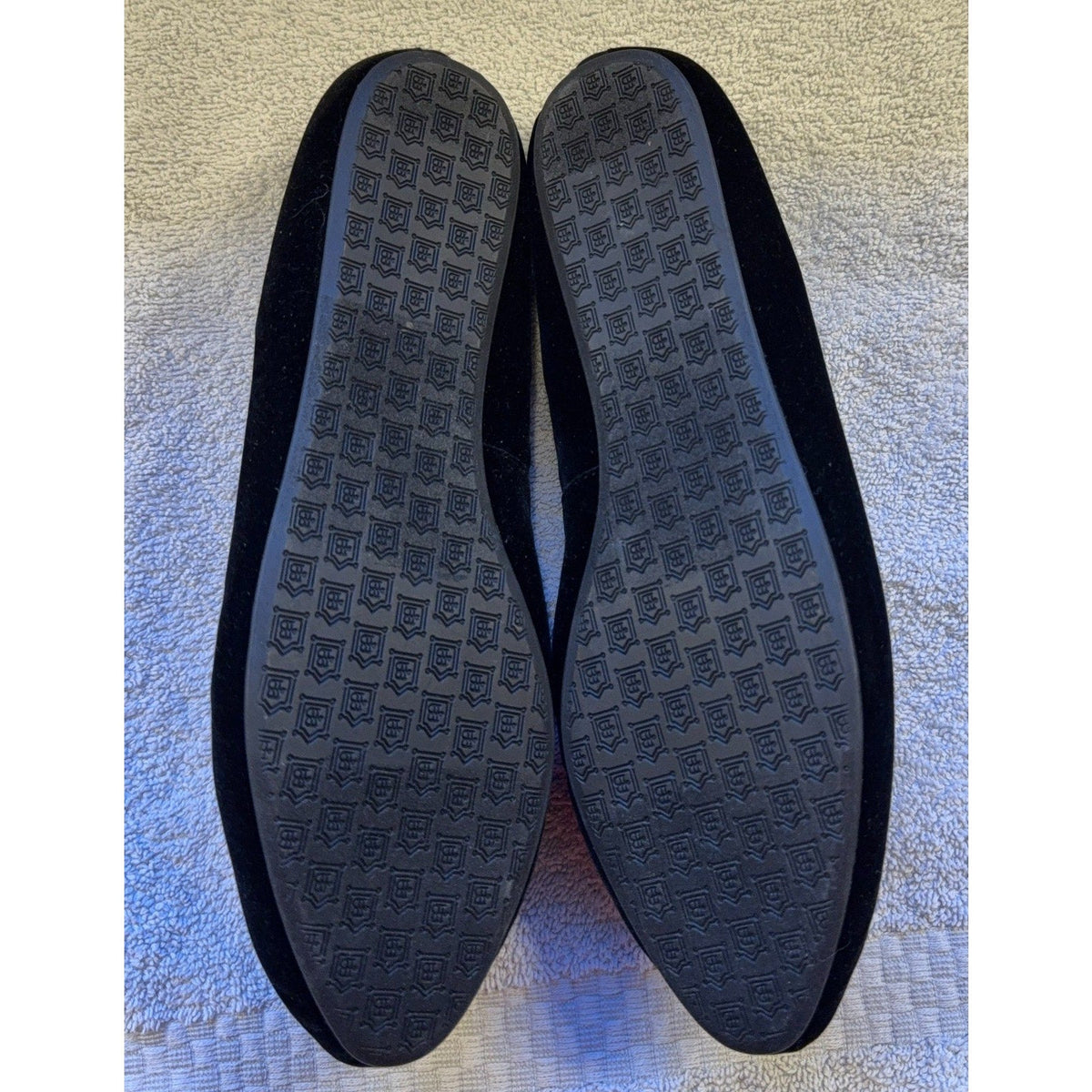 Second Half Supply Co, LLC Birdies black velvet flats showing the black rubber outsoles with a repeating logo pattern.