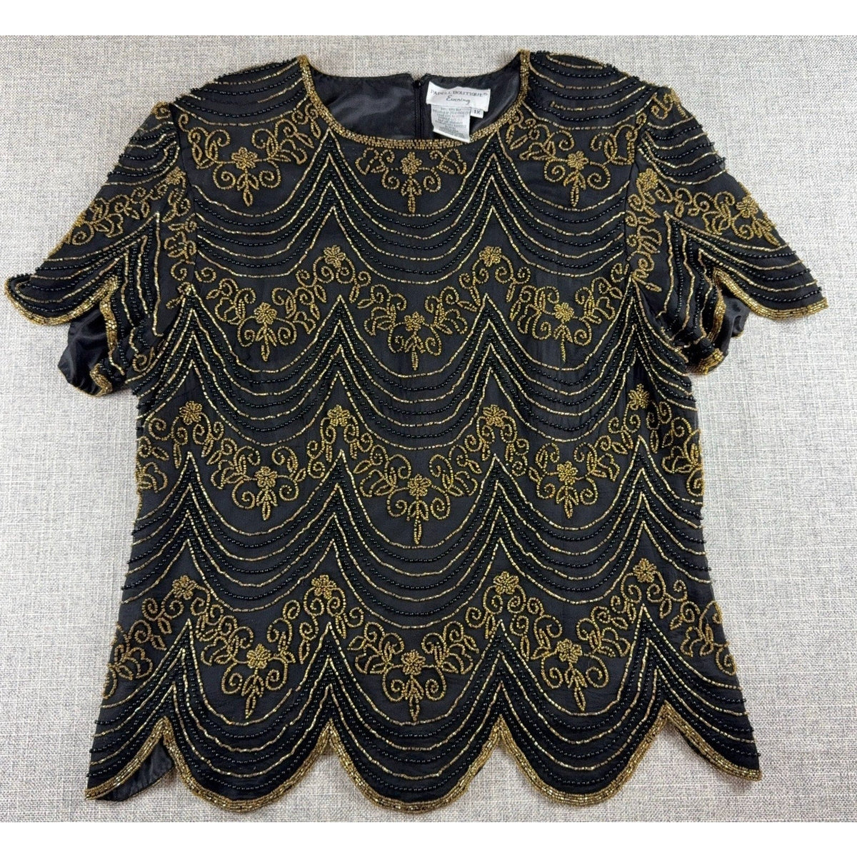 Second Half Supply Co, LLC black silk blouse with gold Art Deco beadwork, scalloped edges, and short sleeves.