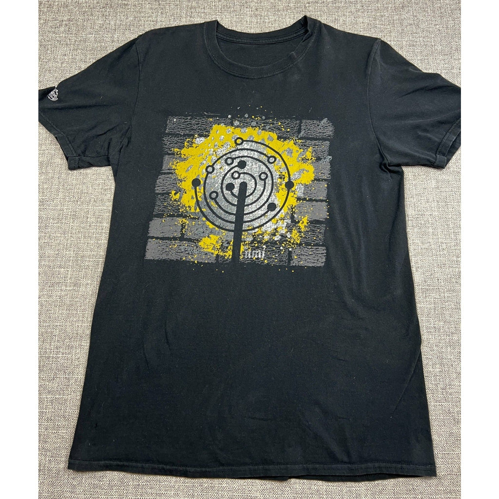 Second Half Supply Co, LLC black crewneck t-shirt with a yellow and white brick wall graphic design on the front