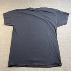 Back view of a plain black Second Half Supply Co, LLC men's medium casual t-shirt on a grey fabric background.
