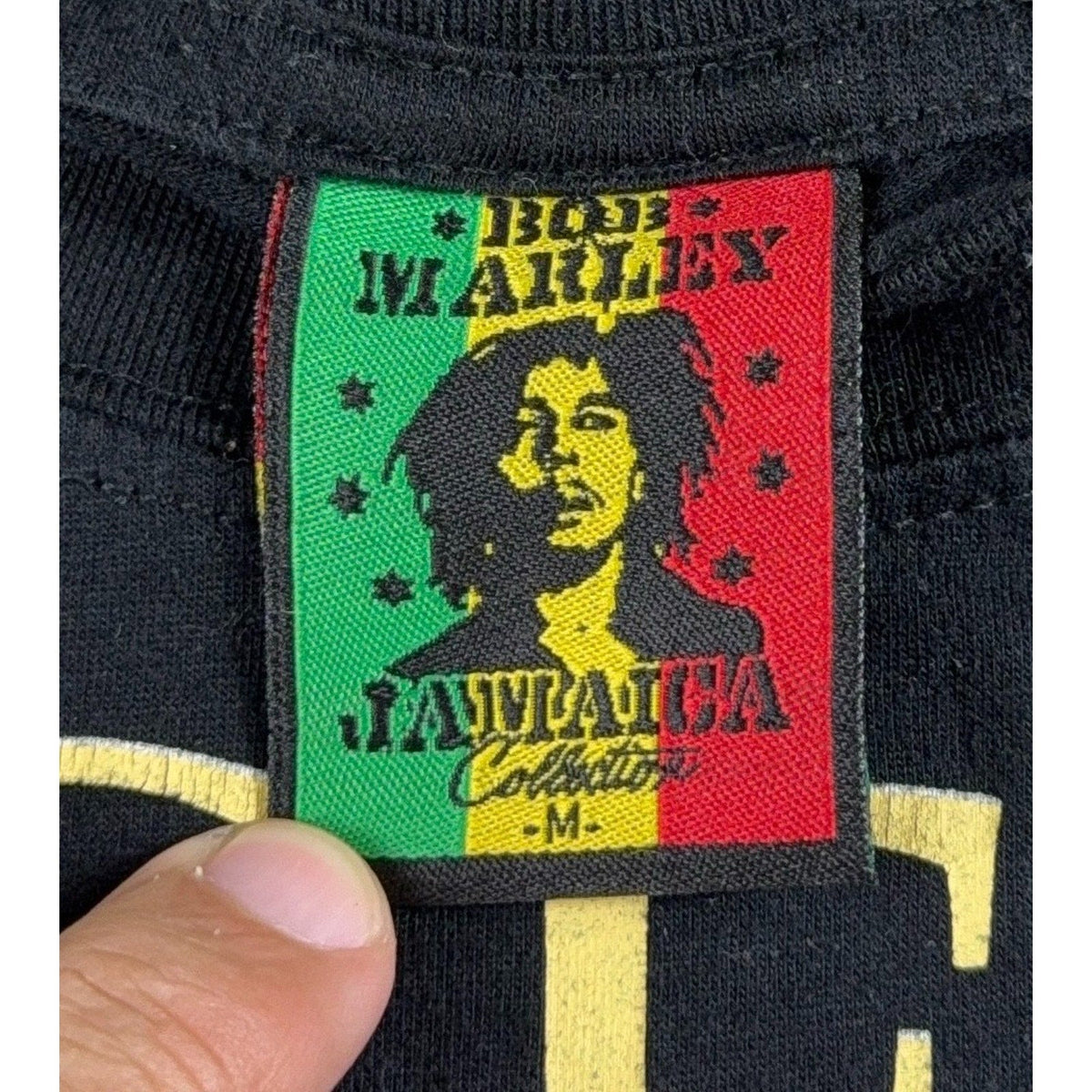 Second Half Supply Co, LLC Bob Marley Jamaica Collection tag on a black cotton blend graphic t-shirt