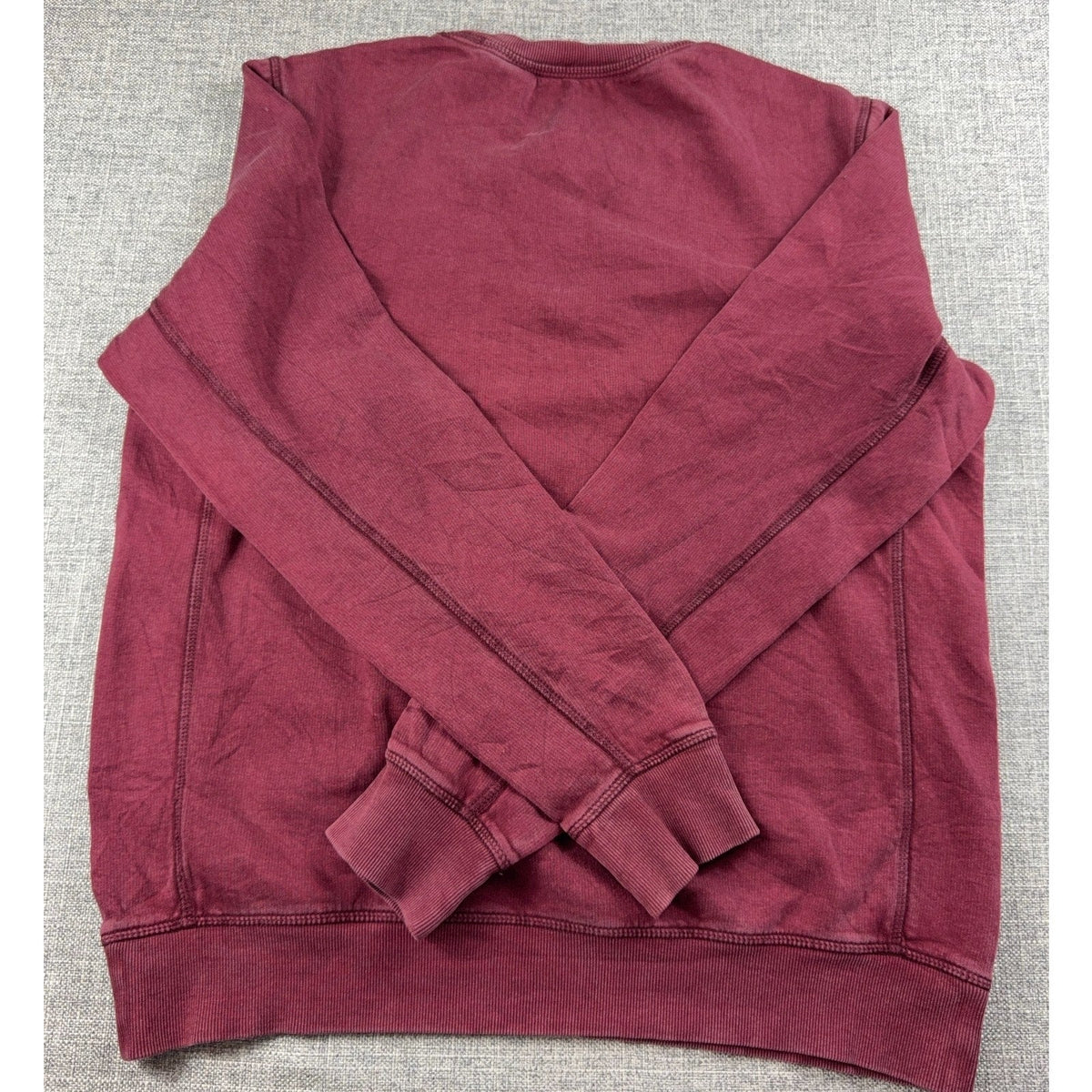 Back view of a Second Half Supply Co, LLC burgundy Timberland crewneck sweatshirt with ribbed cuffs and hem.