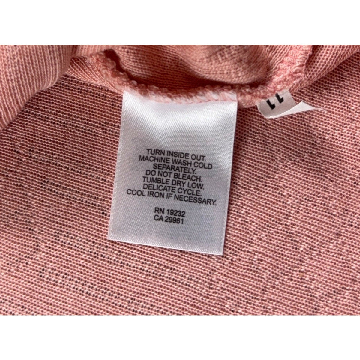 Second Half Supply Co, LLC vintage pink pointelle sweater care label with washing instructions and RN number