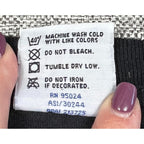 Second Half Supply Co, LLC care label on a black heavyweight cotton T-shirt showing washing instructions