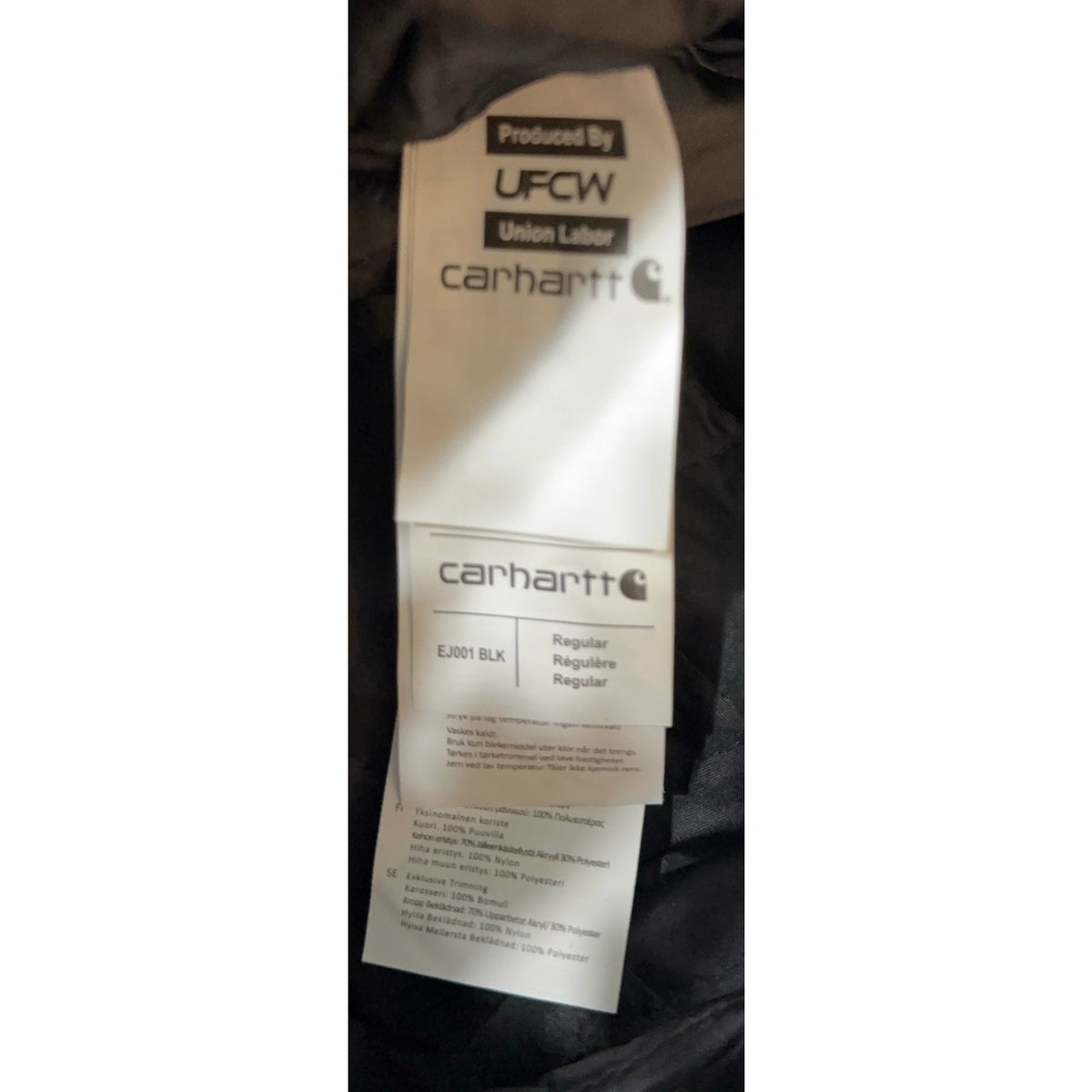 Second Half Supply Co, LLC Carhartt jacket interior care and origin label showing union labor and size regular
