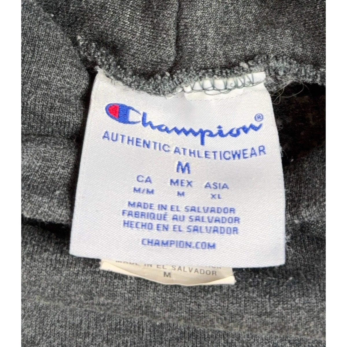 Second Half Supply Co, LLC Champion hoodie size medium tag showing brand logo and manufacturing details