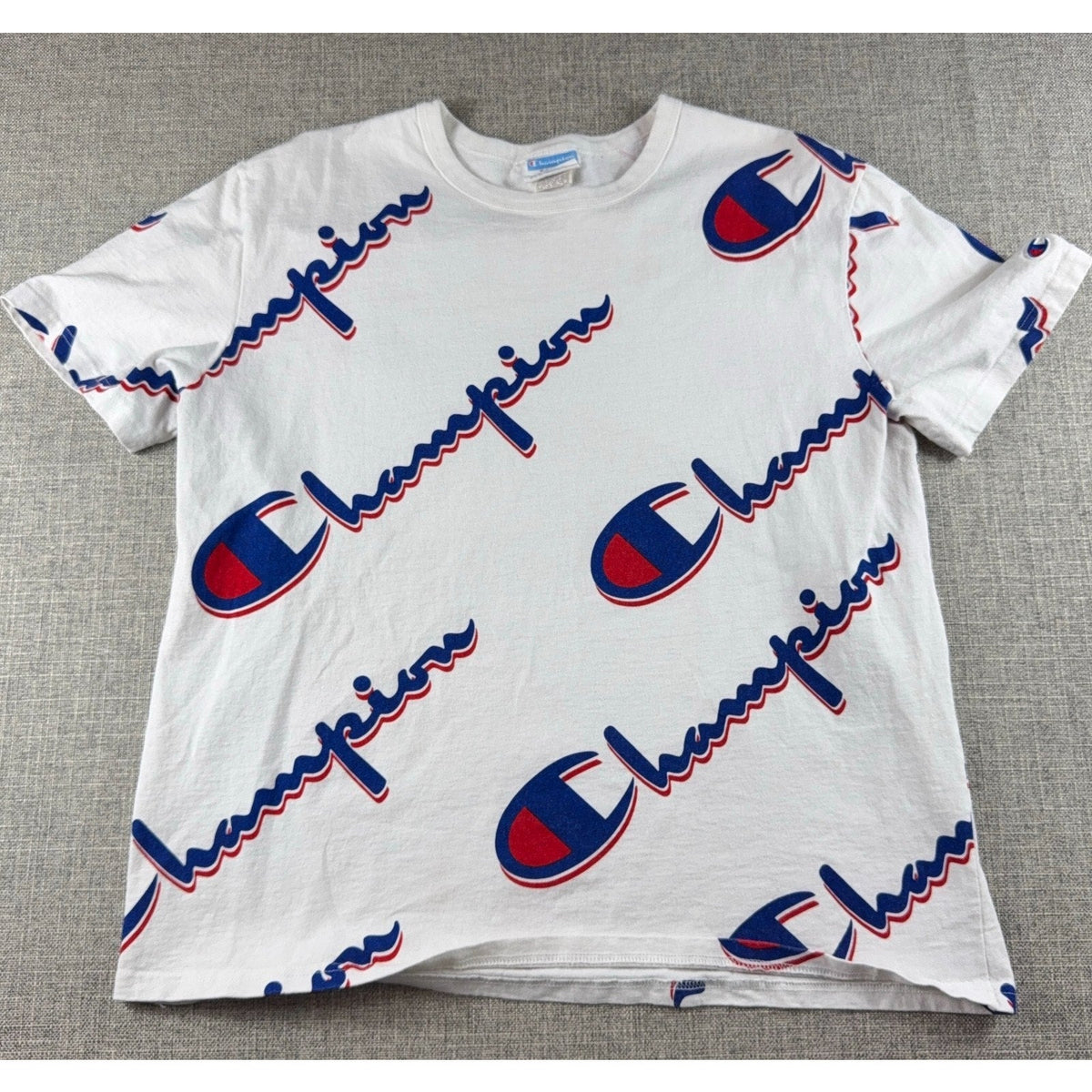 Second Half Supply Co, LLC Champion white cotton t-shirt with red and blue all-over script logo print