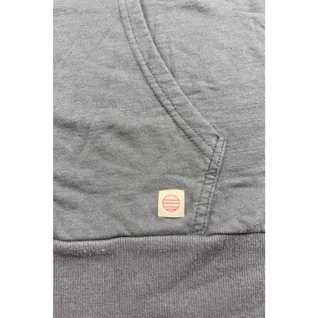Second Half Supply Co, LLC charcoal gray Marine Layer hoodie featuring a small brand logo tab on the kangaroo pocket