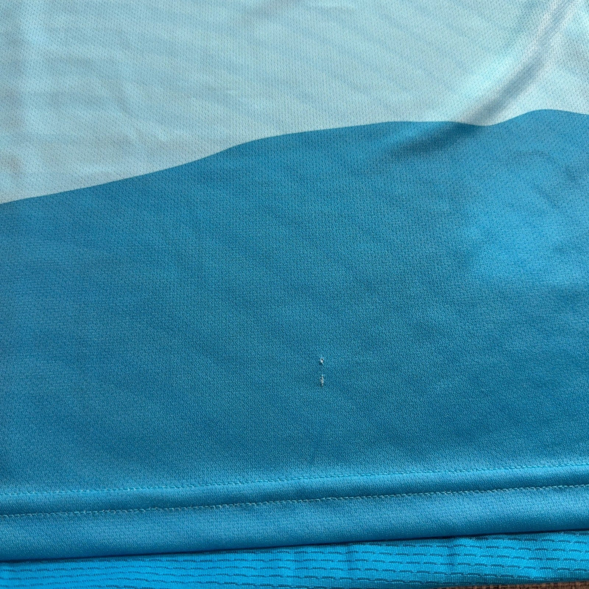 Second Half Supply Co, LLC Charlotte FC soccer jersey showing a small fabric pull on the blue AEROREADY material