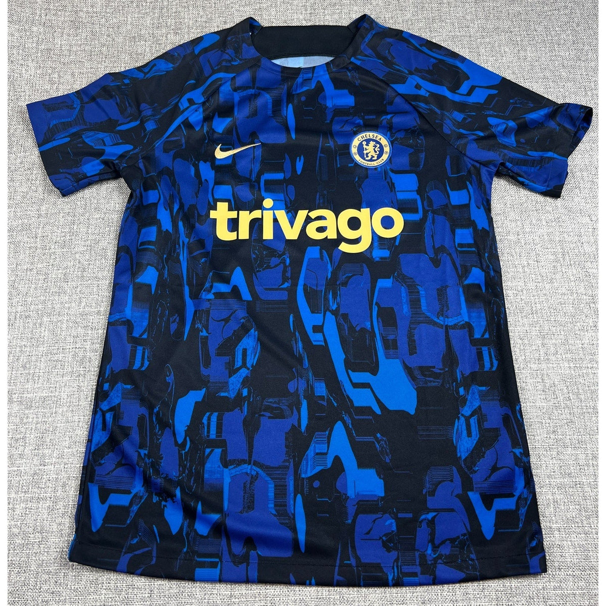Second Half Supply Co, LLC Nike Chelsea FC 2023/24 pre-match soccer top in blue and black with gold sponsor logo.