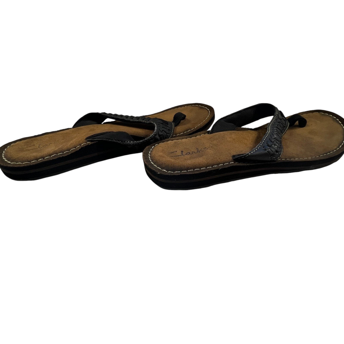 Second Half Supply Co, LLC Clarks women's black leather thong sandals with woven straps and cushioned suede footbeds.