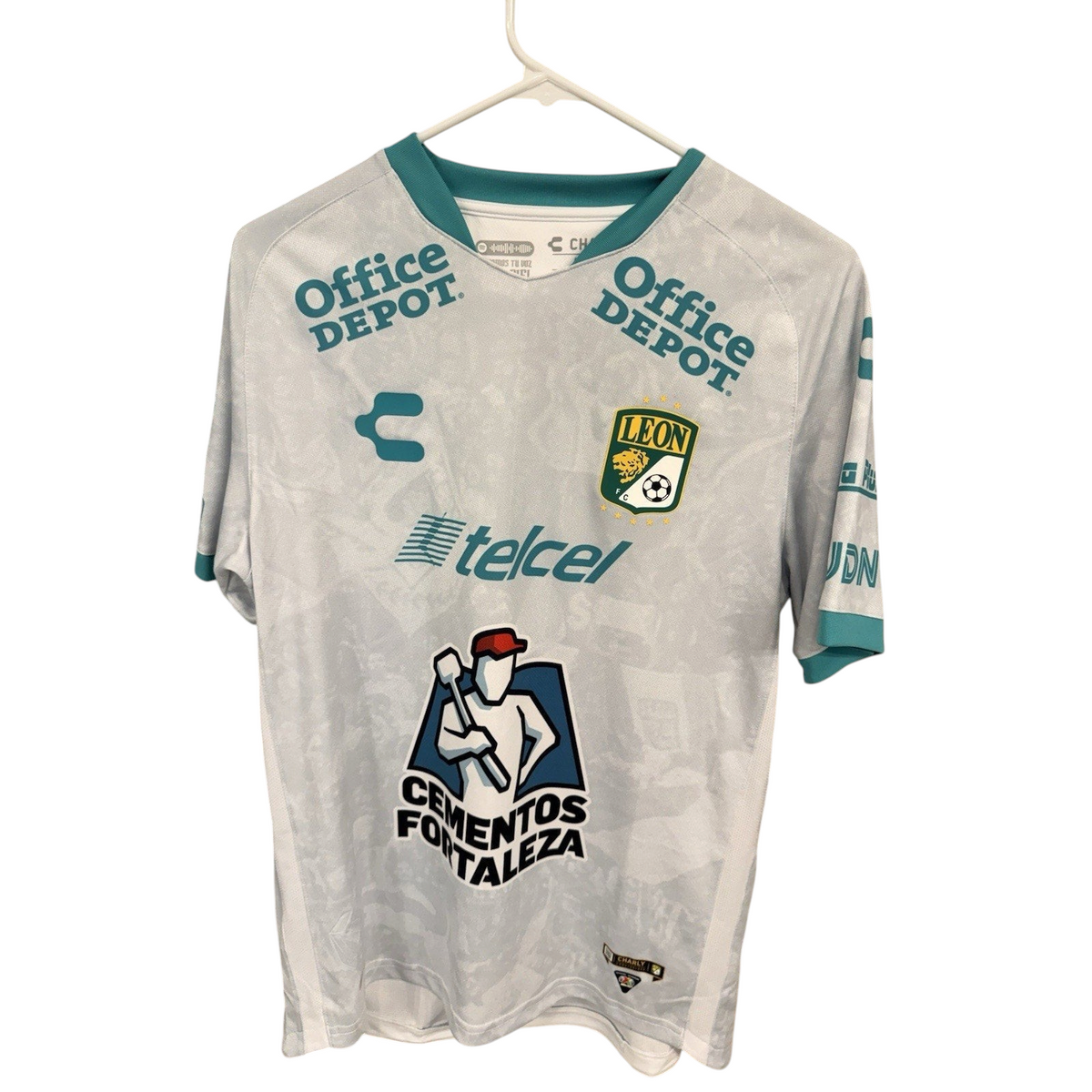 Second Half Supply Co, LLC Club Leon Charly away soccer jersey in white with teal accents and official team sponsors.