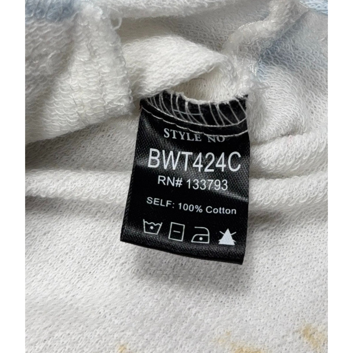 Second Half Supply Co, LLC tag on a white French terry cotton shacket showing style number BWT424C and care symbols.