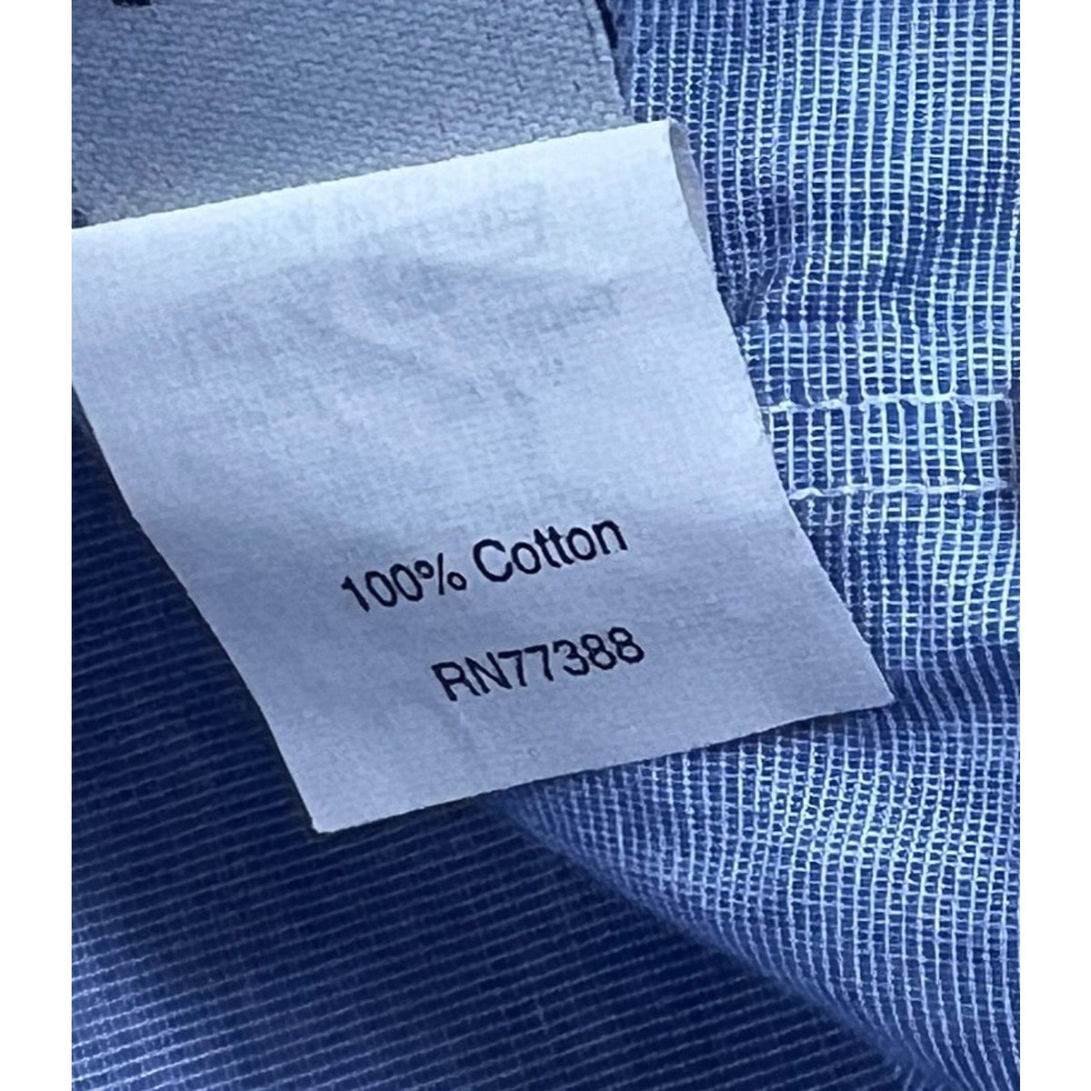 Second Half Supply Co, LLC 100% cotton fabric tag on a blue chambray shirt with RN77388 label