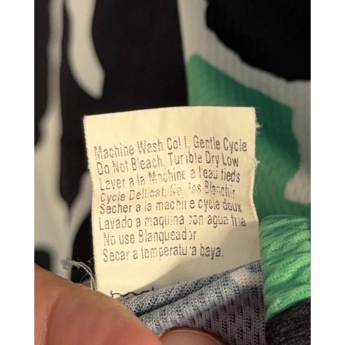 Second Half Supply Co, LLC vintage Pearl Izumi cycling jersey care tag with washing instructions in multiple languages