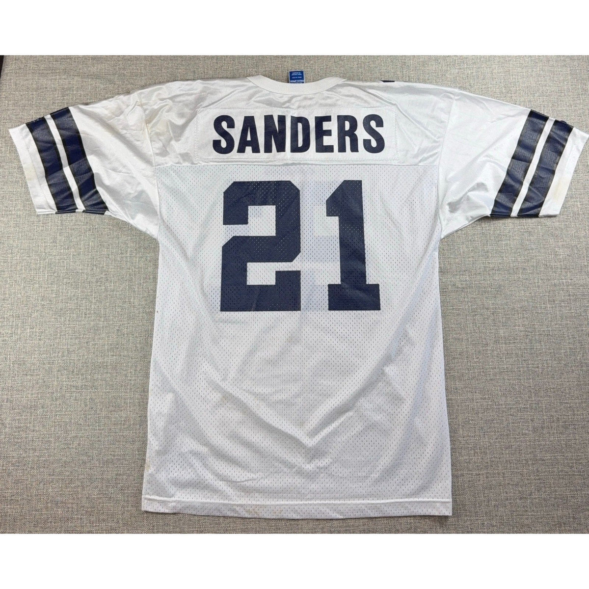 Second Half Supply Co, LLC vintage 90s white Dallas Cowboys Deion Sanders #21 football jersey with navy blue details