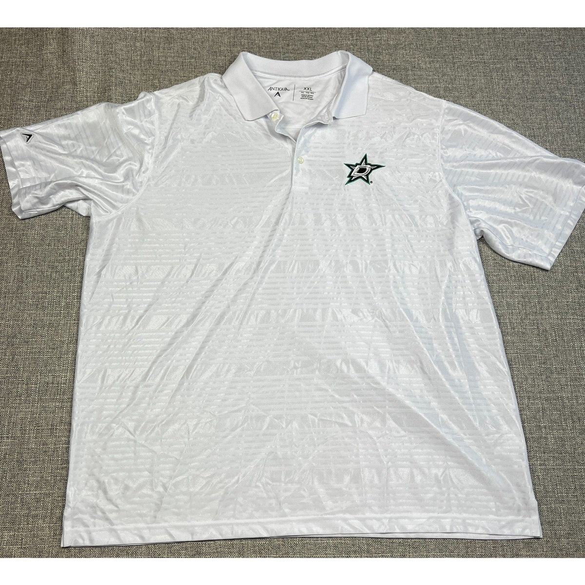Second Half Supply Co, LLC men's white Antigua Dallas Stars polo with tonal geometric pattern and embroidered logo
