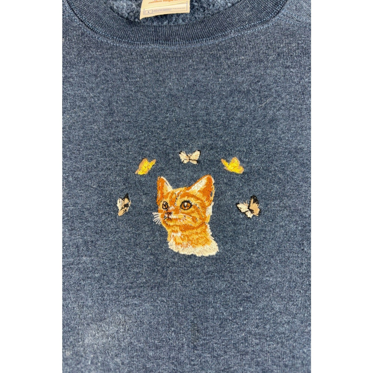 Second Half Supply Co, LLC navy blue crewneck sweatshirt featuring detailed orange kitten and butterfly embroidery.