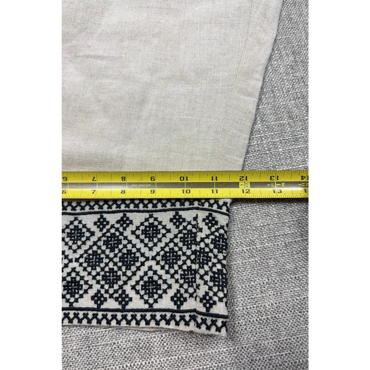 Second Half Supply Co, LLC cream wide leg pants with black geometric embroidery on the hem measured with a tape