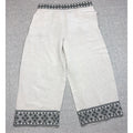 Second Half Supply Co, LLC cream wide-leg cropped pants with black geometric embroidery on the waistband and hems.