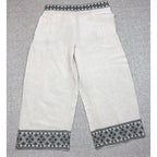 Second Half Supply Co, LLC cream wide-leg cropped pants with black geometric embroidery on the waistband and hems.