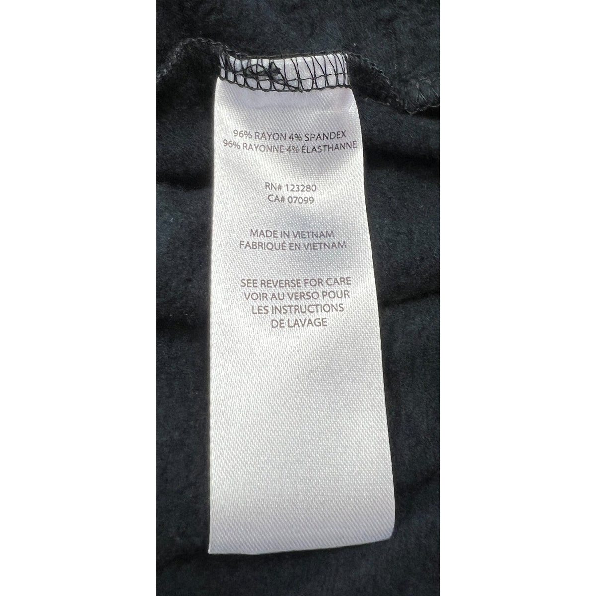 Second Half Supply Co, LLC care tag for TravisMathew black fleece jacket showing 96% rayon and 4% spandex material