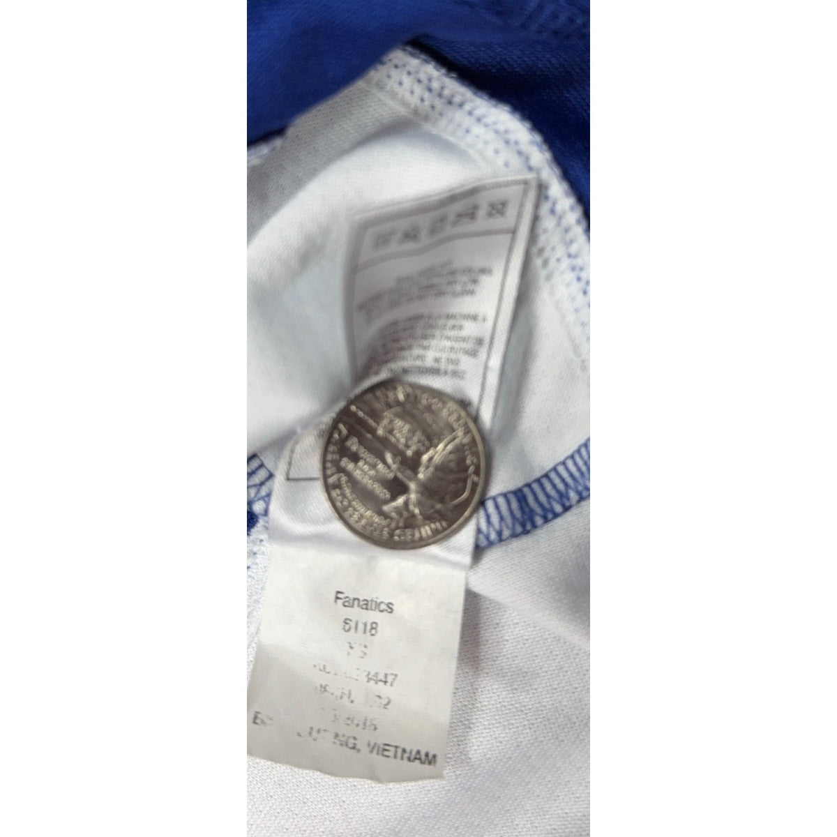 Second Half Supply Co, LLC Fanatics jersey interior care tag with size XS label and a US quarter for scale