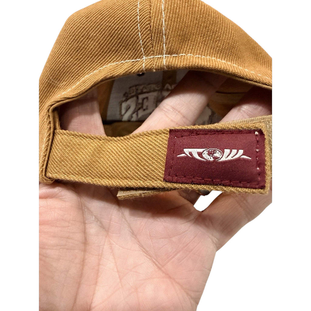 Second Half Supply Co, LLC tan dad cap with adjustable strapback featuring a garnet logo tab detail