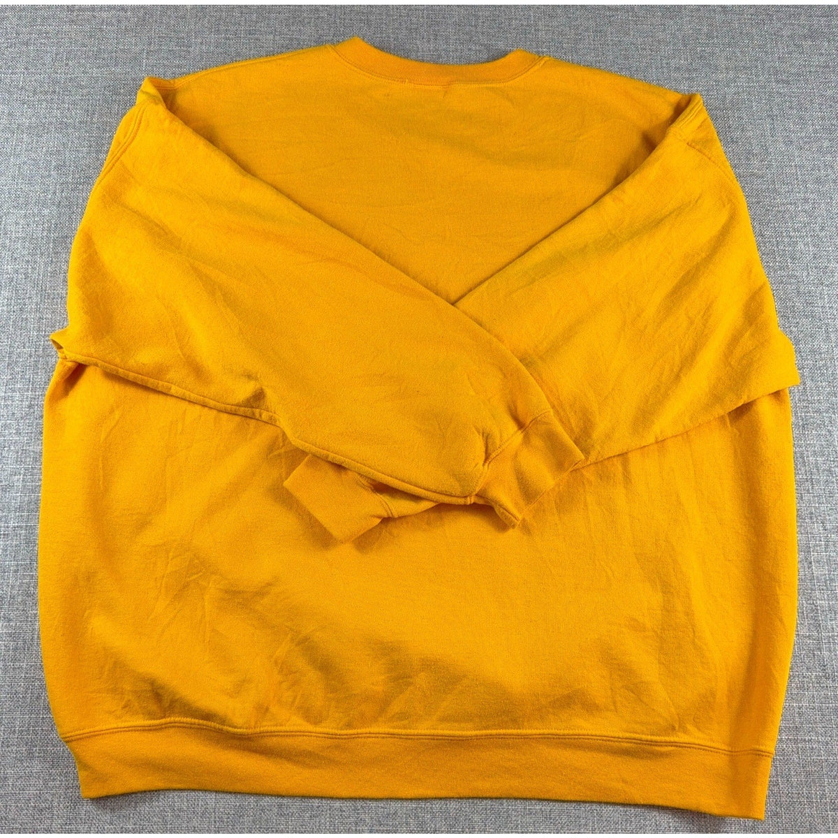 Back view of a plain gold Second Half Supply Co, LLC oversized crewneck sweatshirt with ribbed cuffs and hem.