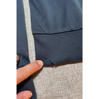 Second Half Supply Co, LLC dark gray athletic hoodie sleeve showing small fabric snags and holes near the cuff