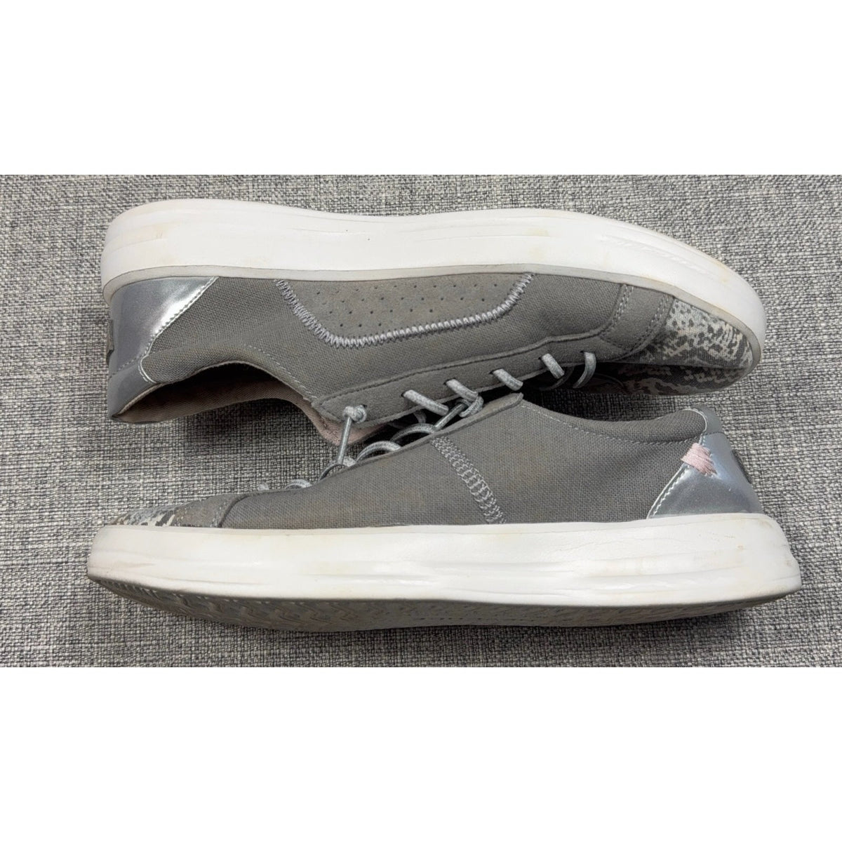 Second Half Supply Co, LLC Hey Dude Karina gray slip-on sneakers with metallic silver heels and snakeskin-print toes.