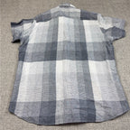 Second Half Supply Co, LLC men's gray and white plaid linen short sleeve shirt, back view with curved hem