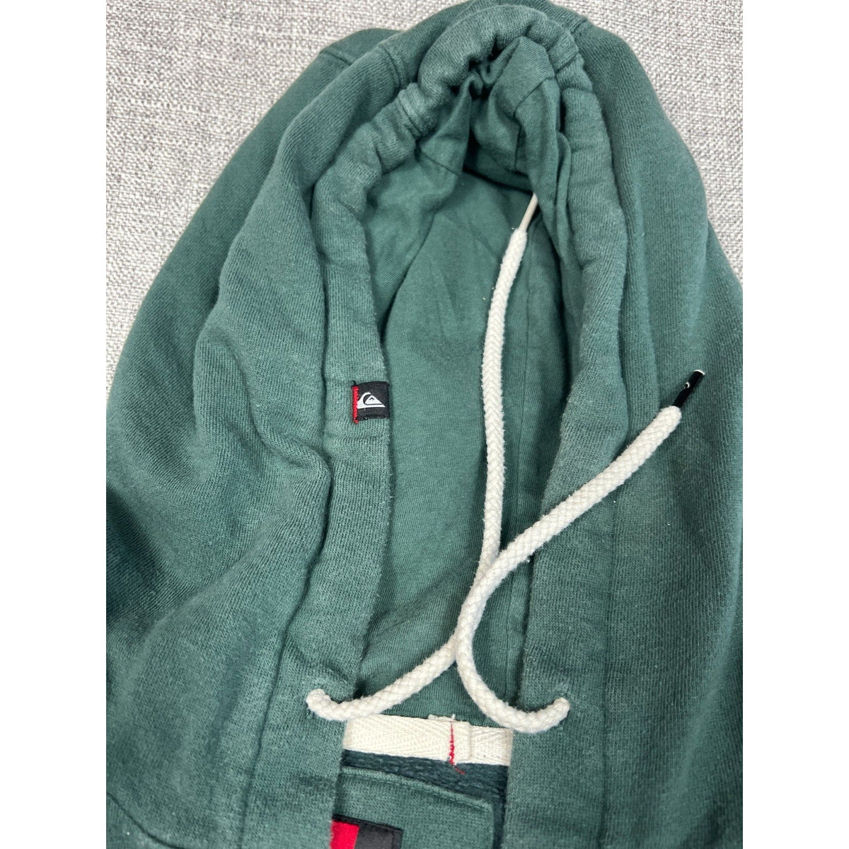 Second Half Supply Co, LLC green Quiksilver fleece hoodie with white drawstrings and branded interior tag detail