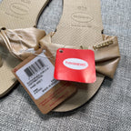 Second Half Supply Co, LLC Havaianas You St Tropez Lush sandals in sand grey with a metallic champagne fabric bow
